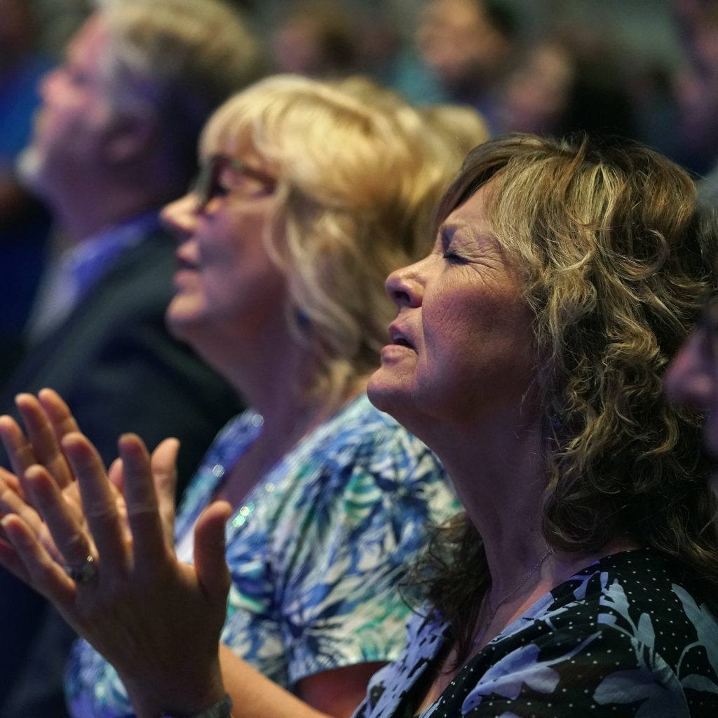 Two women singing and praying